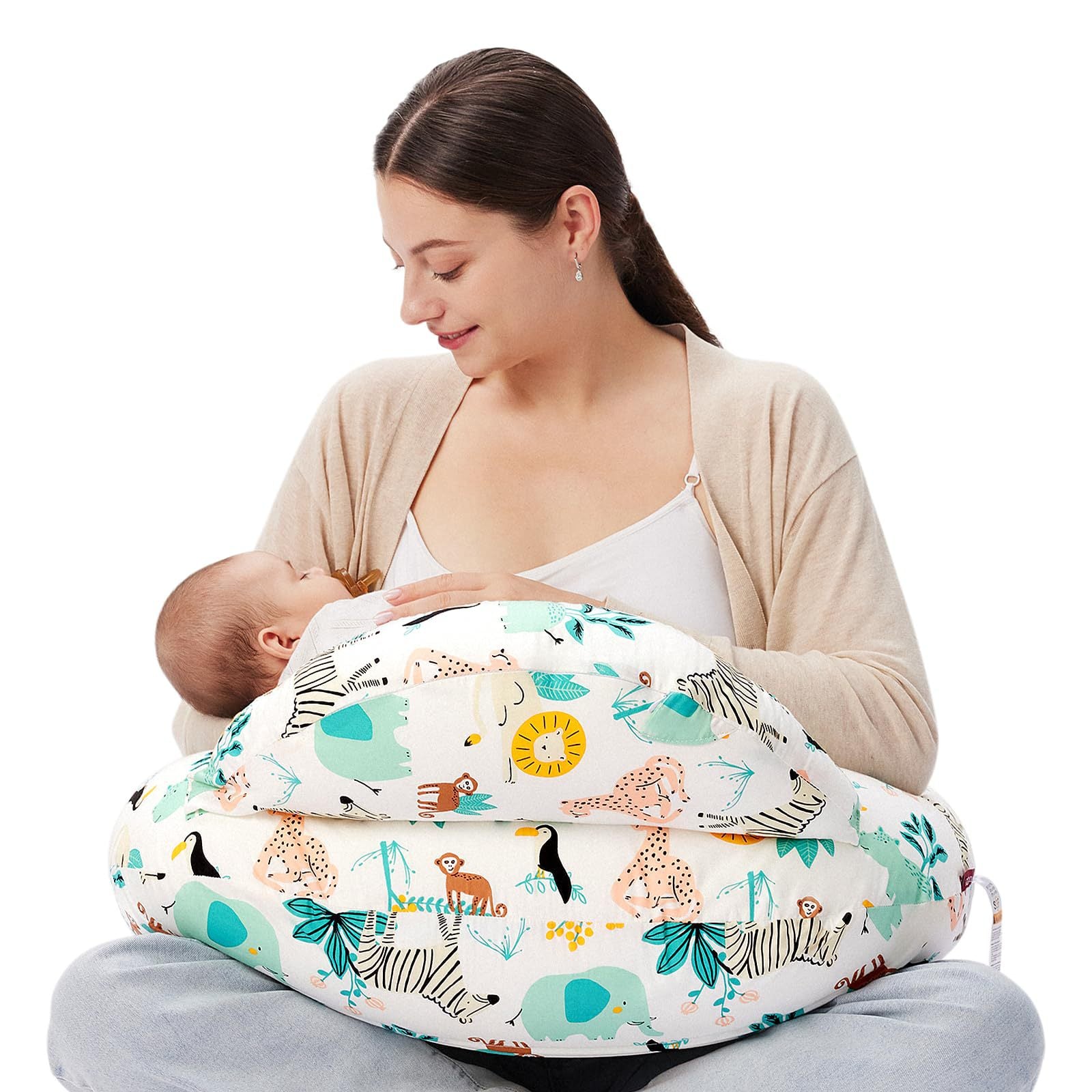 Woman breastfeeding baby using a white multi-functional nursing pillow with colorful jungle animal print.