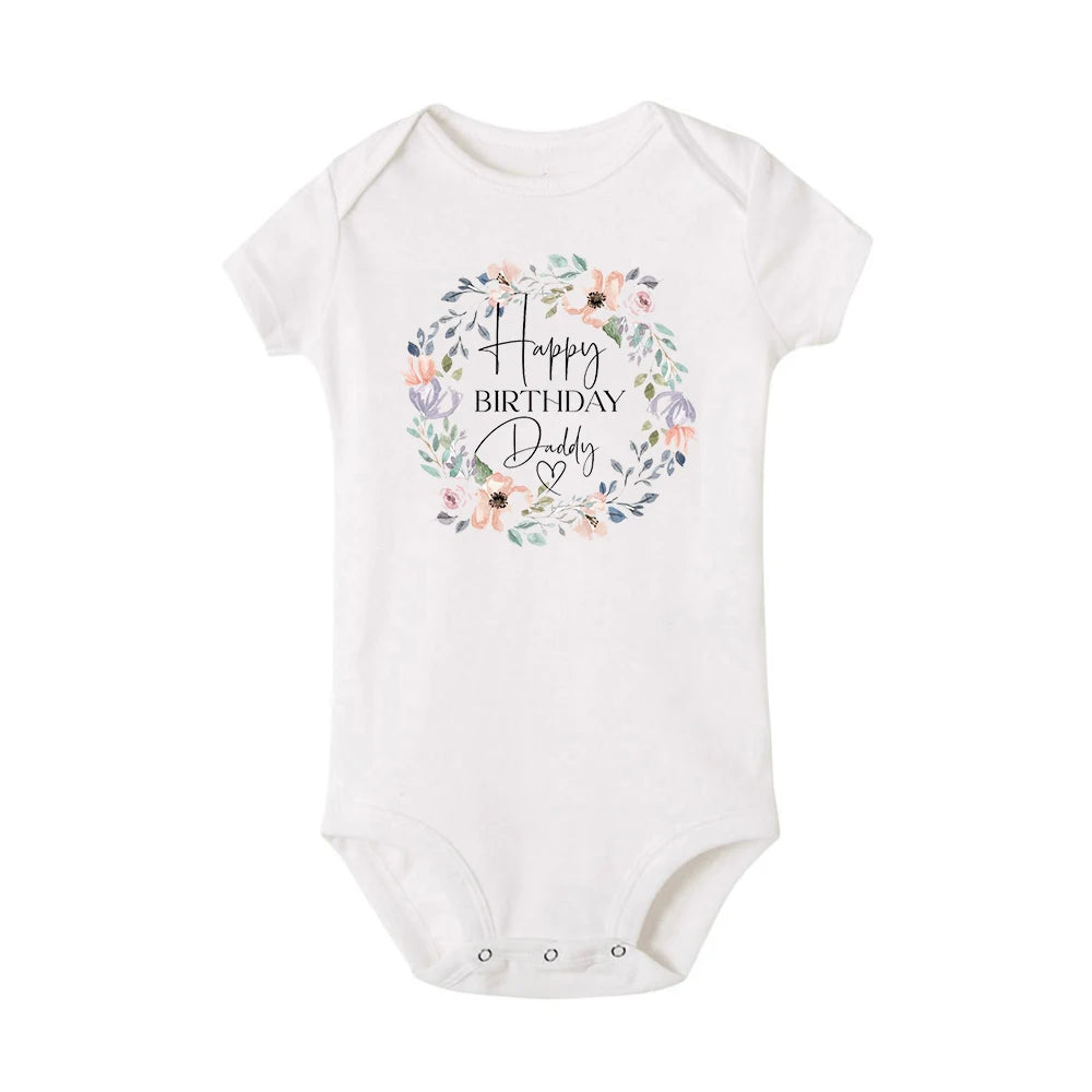 White short-sleeve baby bodysuit with "Happy Birthday Daddy" in a floral wreath design.