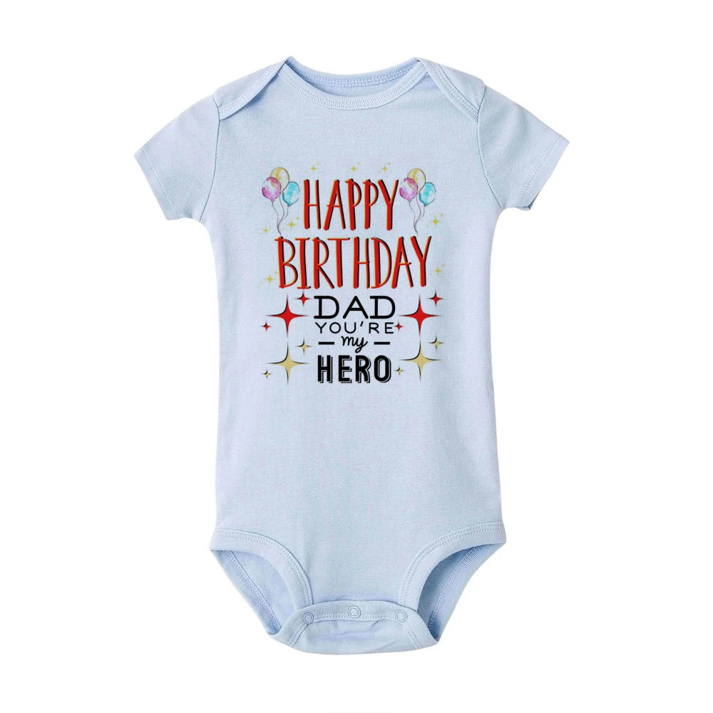 Light blue short-sleeve baby bodysuit with "Happy Birthday Dad You're My Hero" text and balloons.