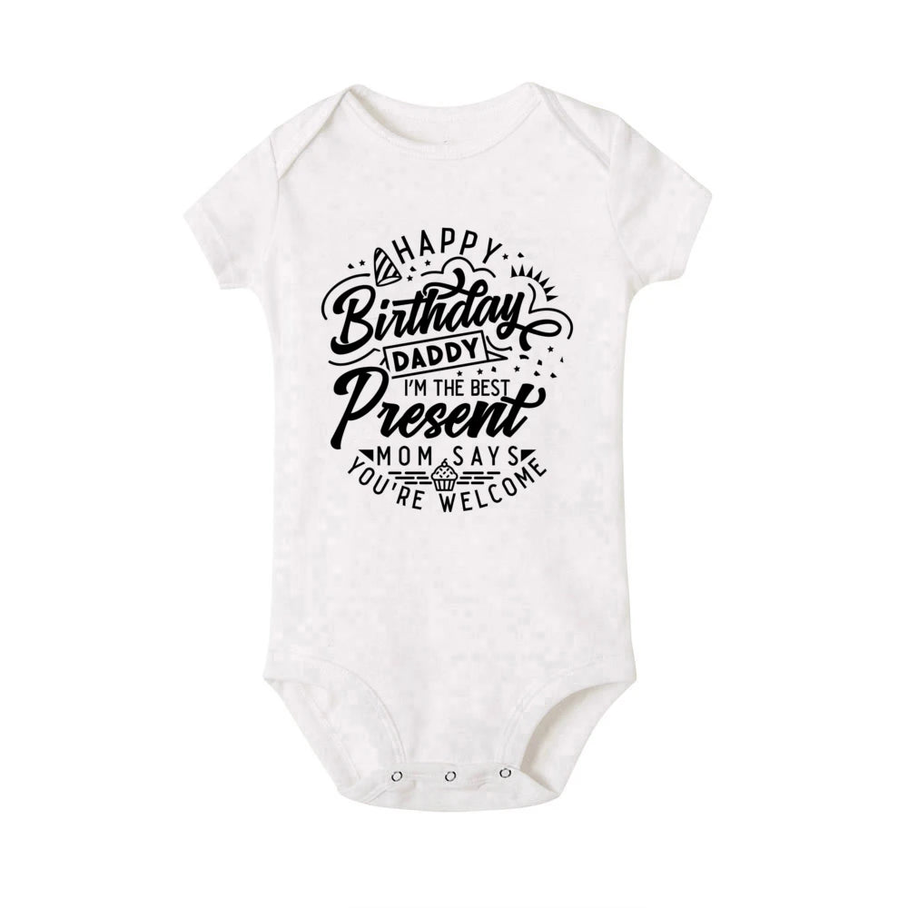White short-sleeve baby bodysuit with "Happy Birthday Daddy I'm the Best Present Mom Says You're Welcome" text.