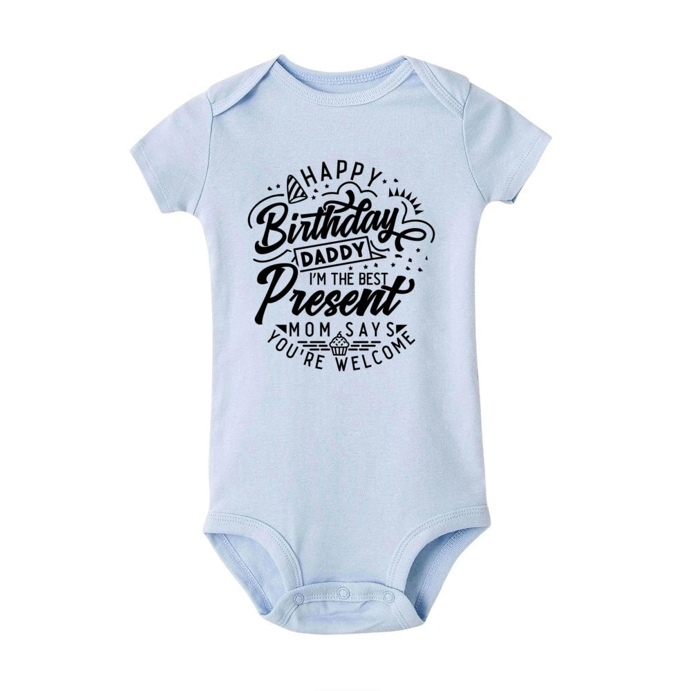 Light blue baby bodysuit with "Happy Birthday Daddy I'm the Best Present Mom Says You're Welcome" text.