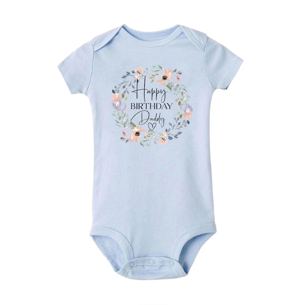 Light blue short-sleeve baby bodysuit with "Happy Birthday Daddy" in a floral wreath design.