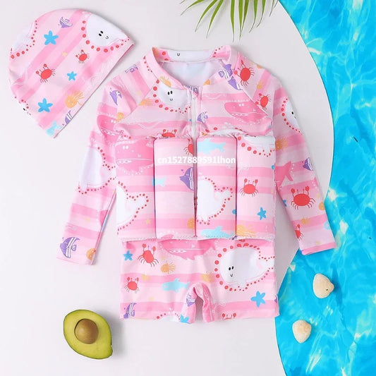 Pink long-sleeve kids' floatation swimsuit with cartoon sea creature print and matching swim cap.