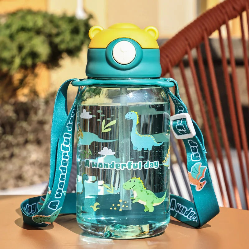 Kids' 650ml clear plastic water bottle with dinosaur print, teal strap, and yellow bear-ear lid with straw.