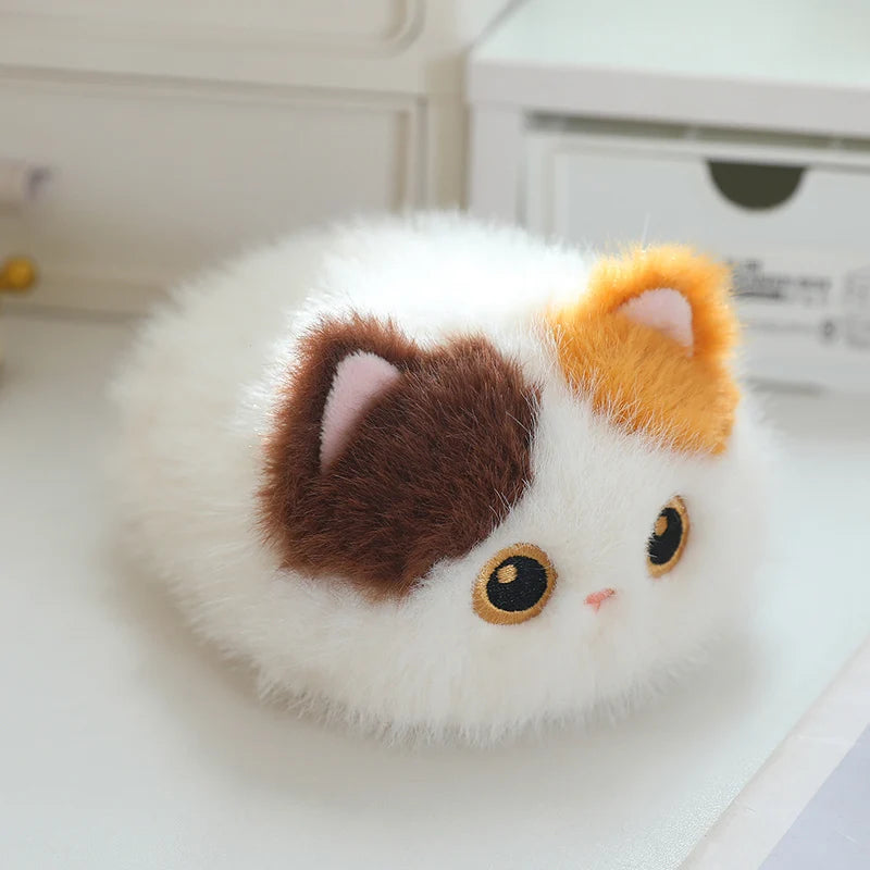 Soft, fluffy white cat plush with brown and orange patches, round design, and embroidered eyes.