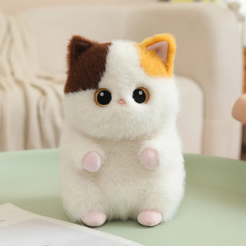 Soft, fluffy white cat plush with brown and orange ears, big eyes, and tiny pink paws.