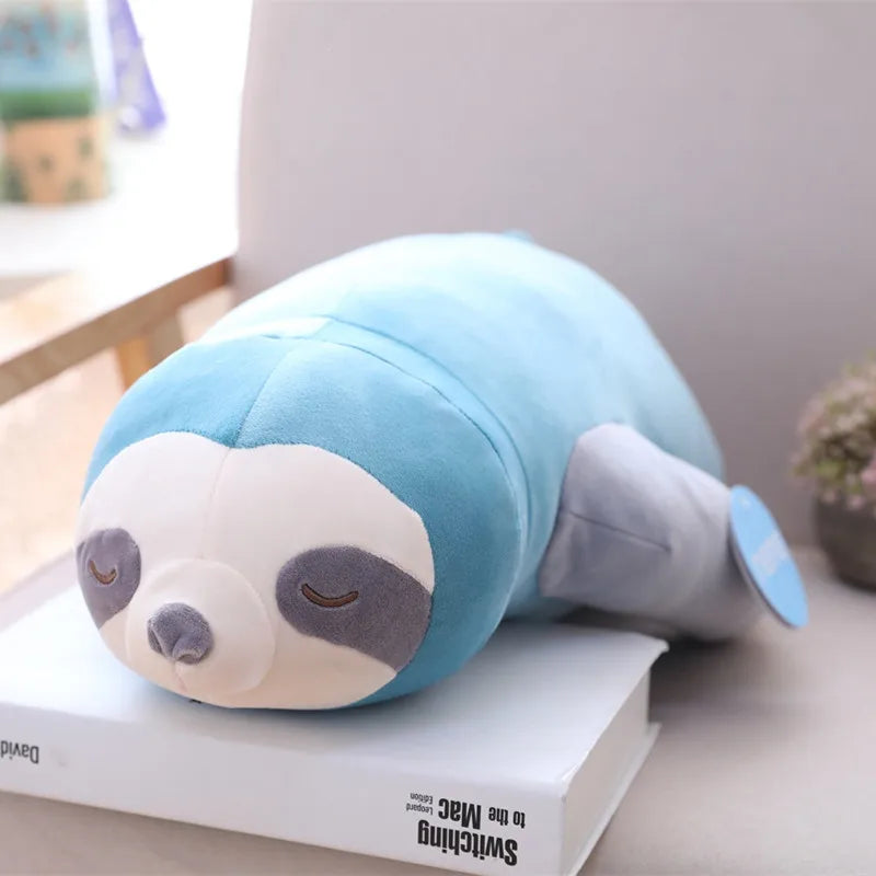 Soft blue plush sloth toy, 65-100cm, with closed eyes and gray face, resting on a book.