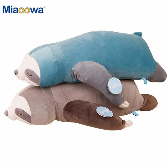 Two soft plush sloth toys, one blue and one brown, lying stacked.