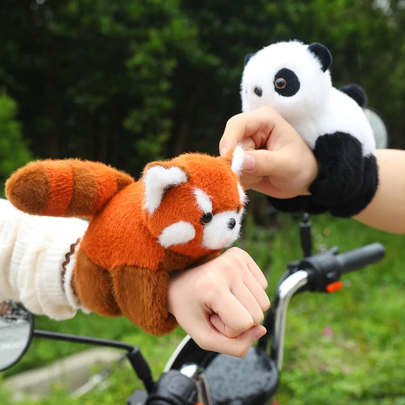 Soft plush red panda and panda wristbands for babies, 20cm, on hands over a motorcycle.