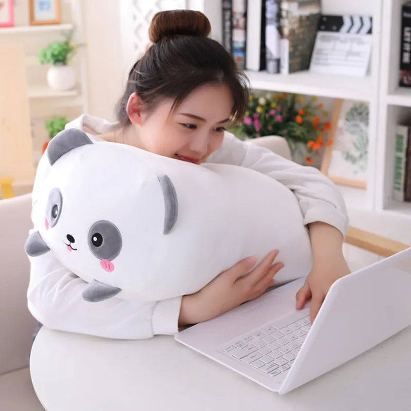 Woman hugging a soft white panda plush pillow, 90cm, while using a laptop.