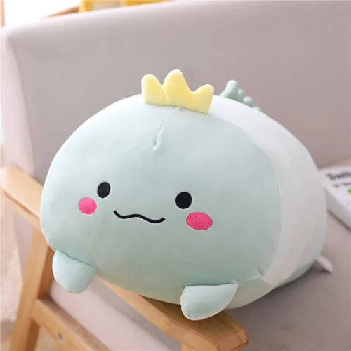 Soft mint green plush dinosaur toy with a yellow crown, black eyes, and pink cheeks.
