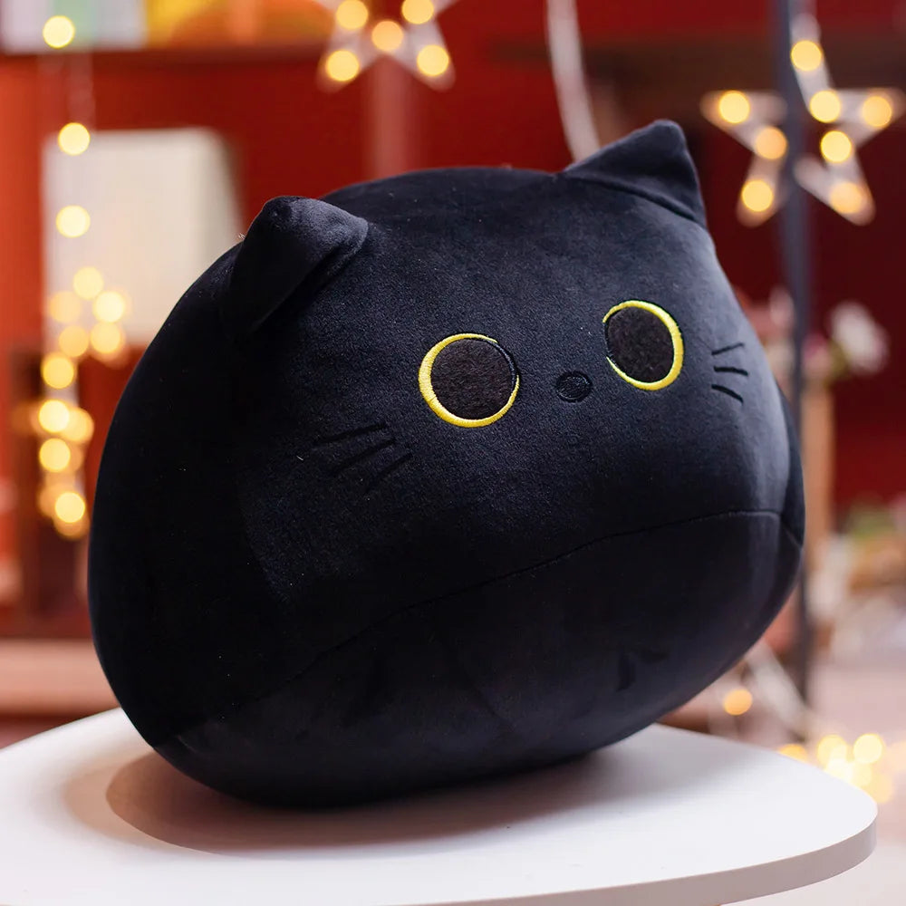Soft black plush cat toy with yellow embroidered eyes and whiskers.