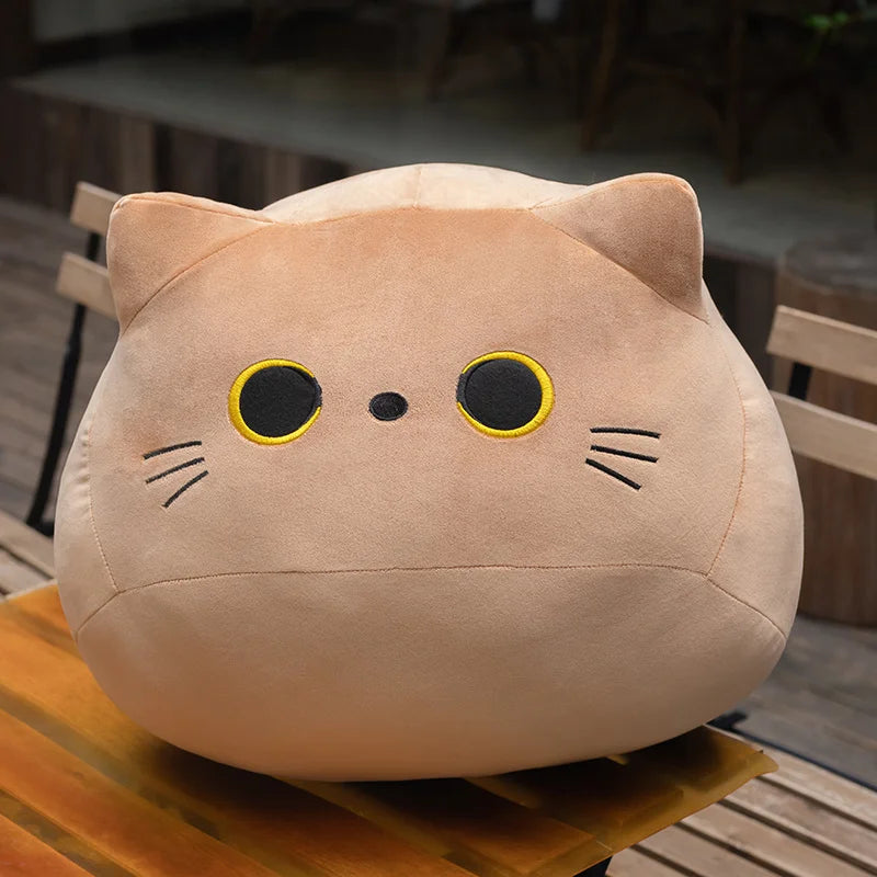 Soft brown plush cat toy with black and yellow eyes, whiskers, and small ears.