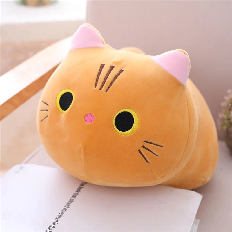 Soft orange plush cat toy with pink ears and embroidered features.