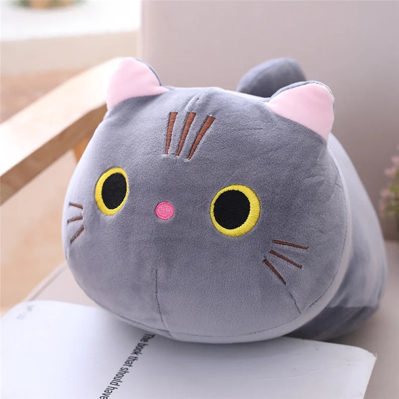 Soft gray plush cat toy with pink ears, yellow eyes, and embroidered whiskers.