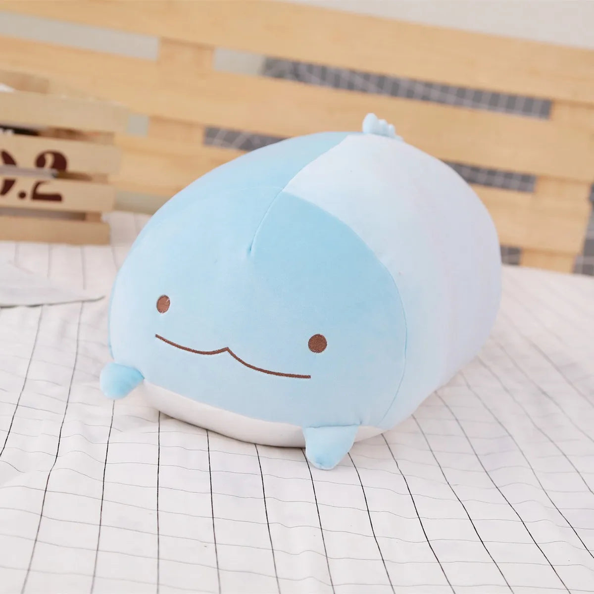 Soft blue plush animal toy for babies, featuring a cute cartoon face.