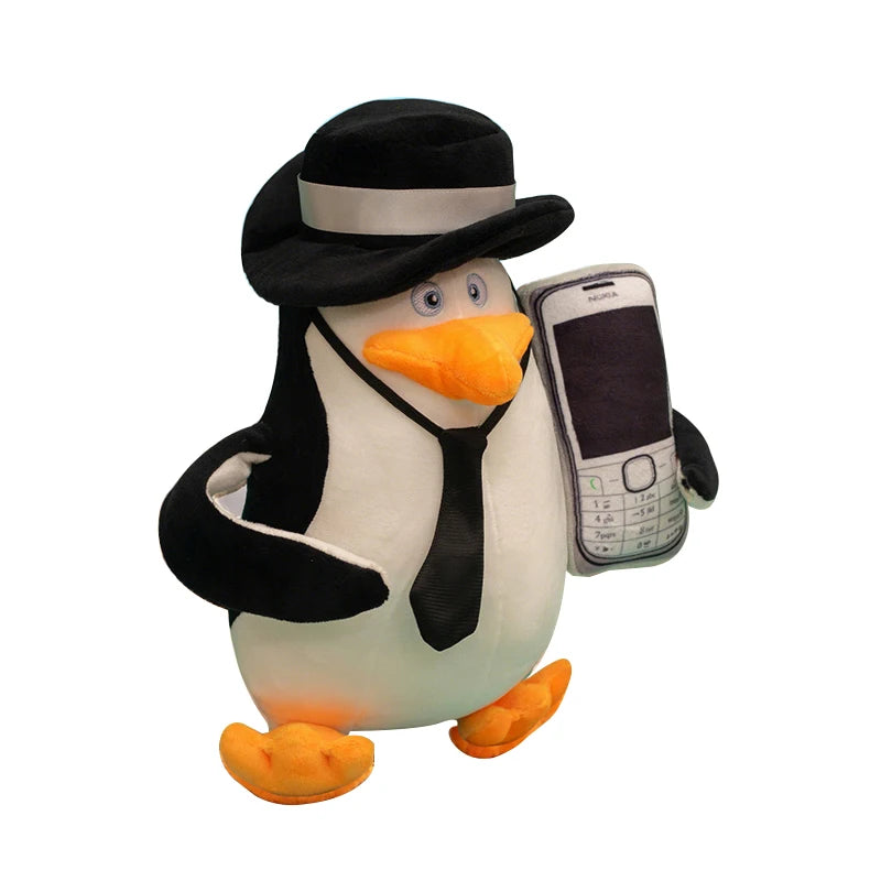 Soft 28cm Madagascar penguin plush toy wearing a black fedora and tie, holding a Nokia phone.