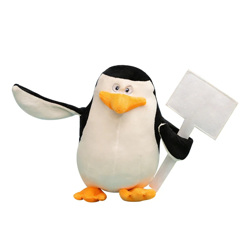 Soft black and white Madagascar penguin plush toy, 28cm, holding a blank white sign.