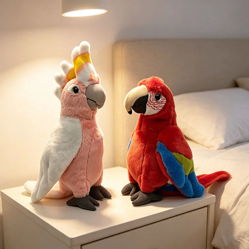 Two soft plush parrot toys, a pink cockatoo and a red macaw, on a white nightstand.