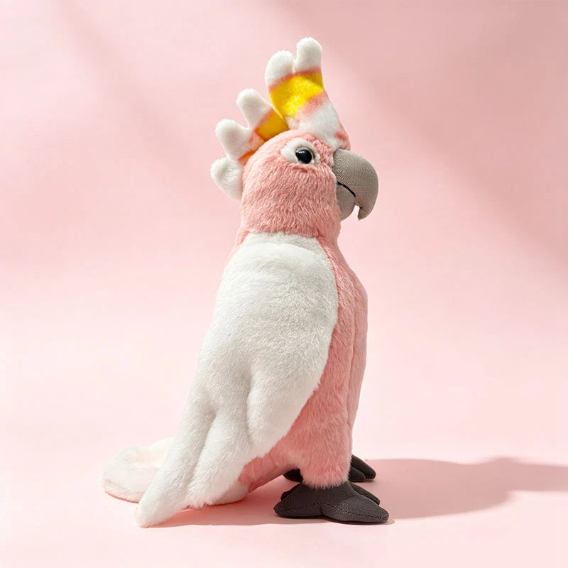 Soft pink cockatoo plush toy, 22cm, with white wings and a yellow-striped crest.