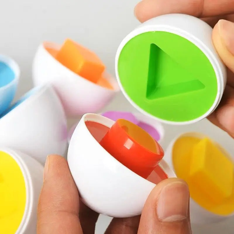 Hands holding colorful Montessori matching eggs with geometric shapes for toddlers.