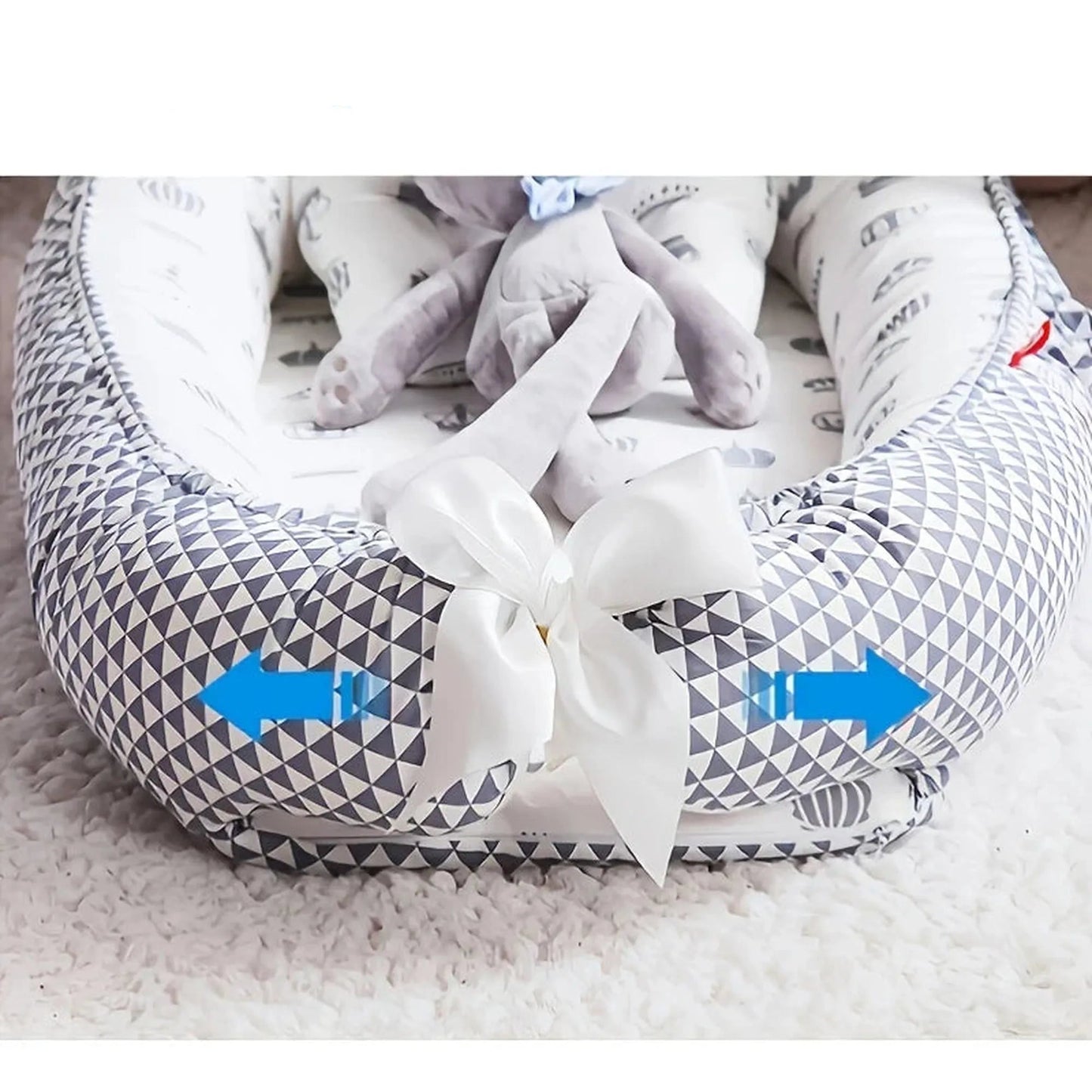 Adjustable baby nest with gray geometric pattern, white bow, and detachable cover.