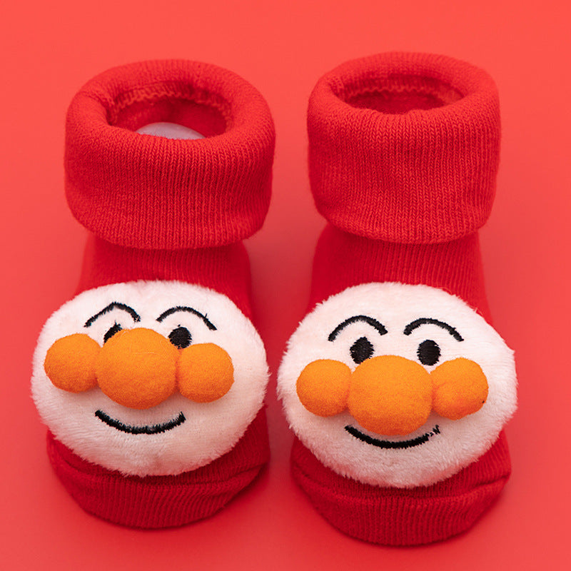 Pair of red cotton baby socks with cute white cartoon faces and orange noses, featuring anti-slip soles.