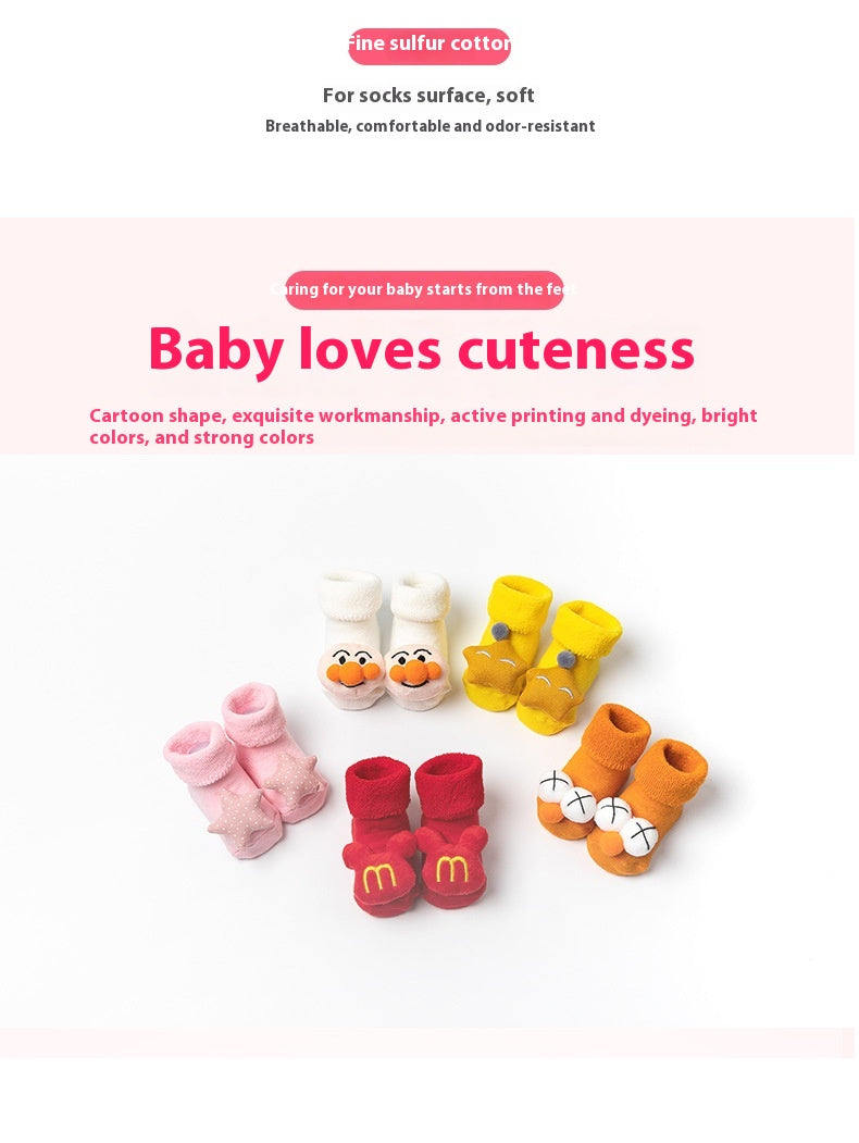 Assorted cotton baby socks with cartoon designs and anti-slip soles in pink, red, yellow, and orange.
