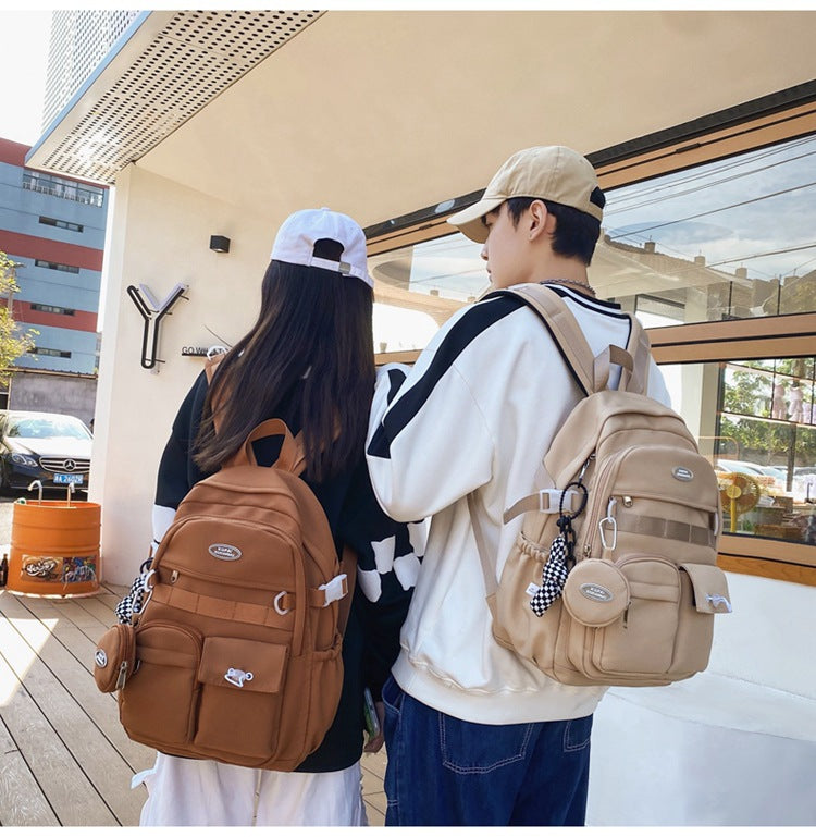 Two students wearing stylish, water-resistant nylon backpacks in brown and beige, with laptop compartments.