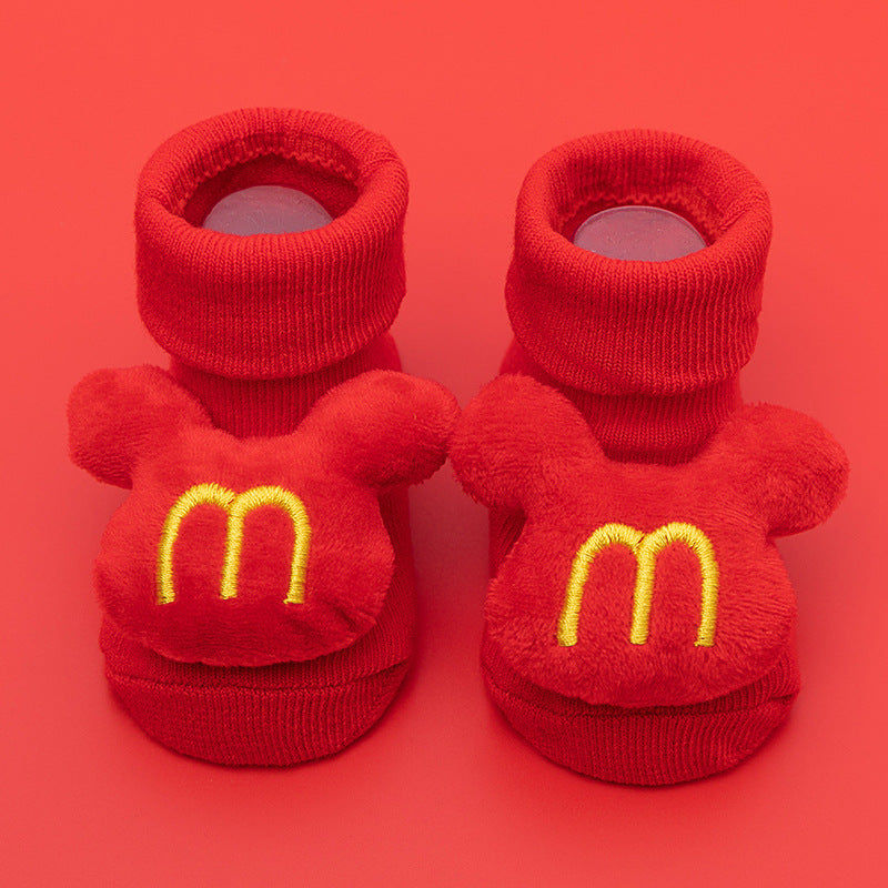 Red cotton baby socks with yellow "M" logo and anti-slip soles, for ages 0-3.