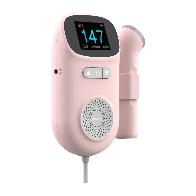 Pink digital fetal doppler monitor with a color TFT screen displaying 147 bpm, speaker, and attached probe.
