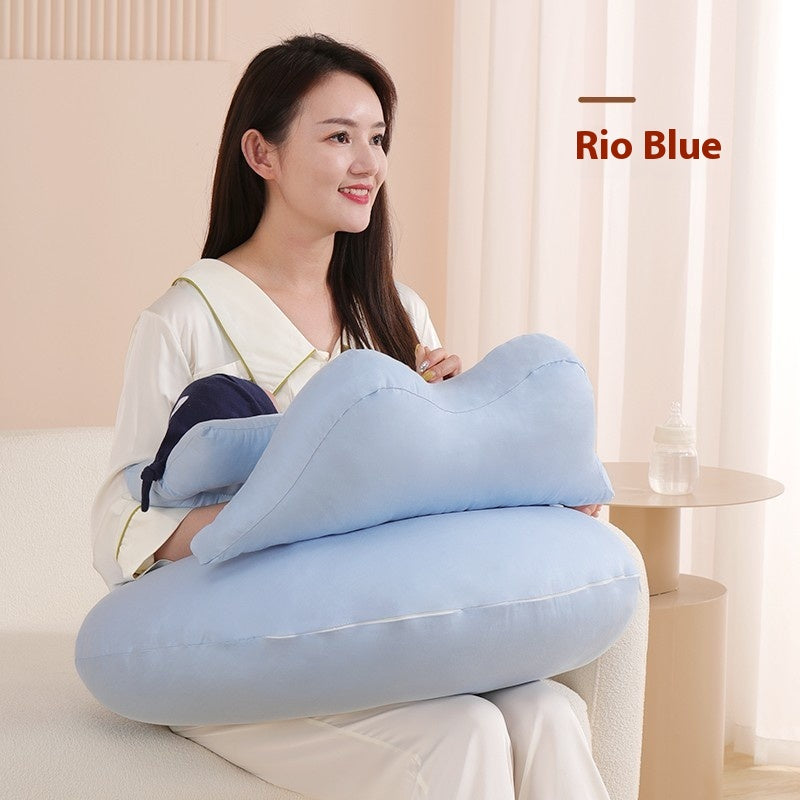 Smiling woman holding a light blue multi-purpose nursing pillow with a small baby pillow.