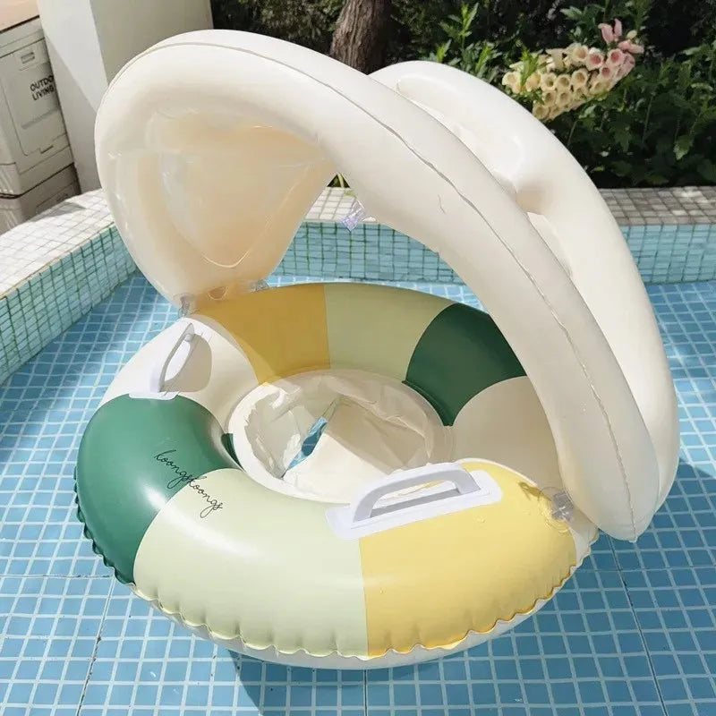 Inflatable baby swim float with sun canopy, featuring green, yellow, and cream color blocks.