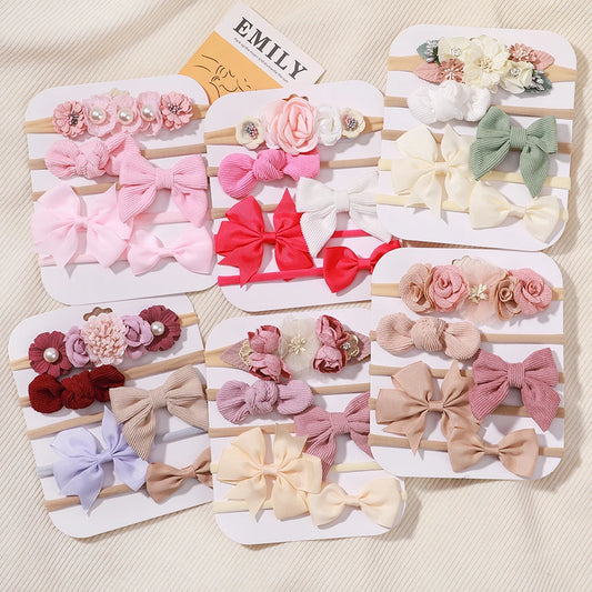 Five sets of soft nylon and cotton baby headbands with lace flowers and bows in various pastel colors.