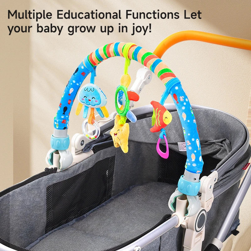 Adjustable baby activity arch with colorful plush sea creature toys attached to a gray stroller.