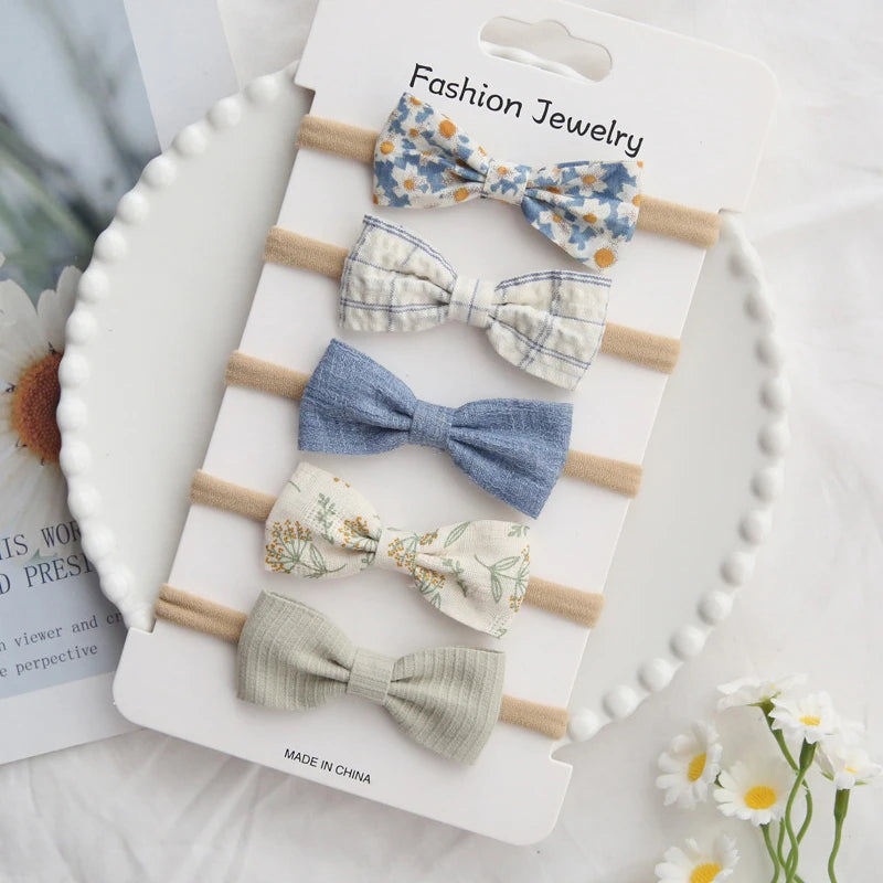Set of 5 handmade cotton baby headbands with bows in various patterns and solid colors.