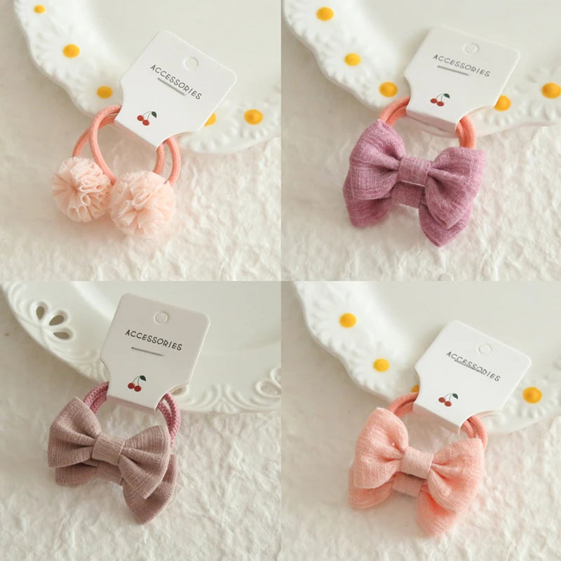 Soft cotton hair ties for babies and girls: pink pom-poms, purple bow, brown bow, peach bow.