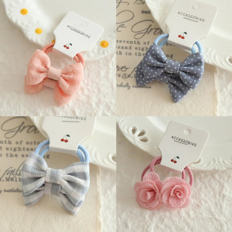 Soft cotton hair ties for babies and girls: pink bow, blue polka dot bow, plaid bow, and pink floral.