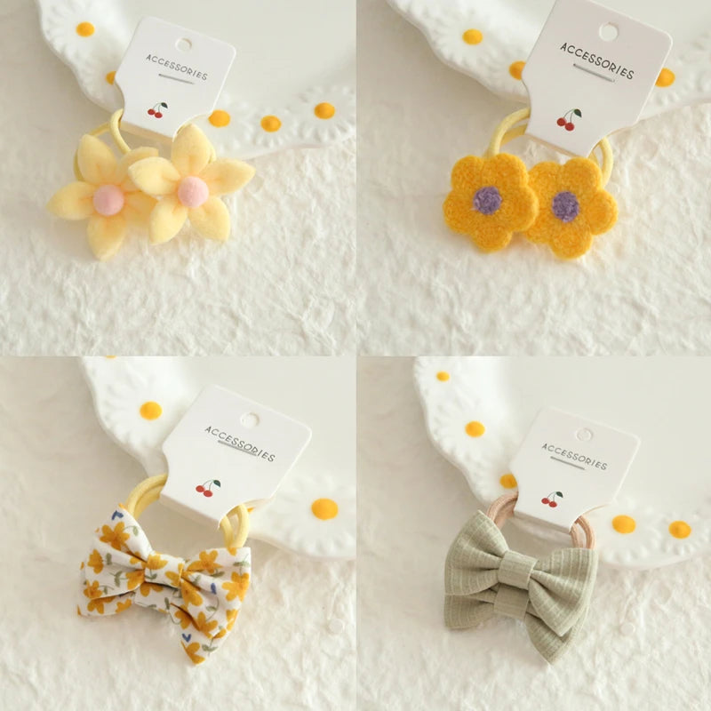 Soft cotton hair ties for babies and girls: yellow flowers, patterned bows, and solid sage bow.