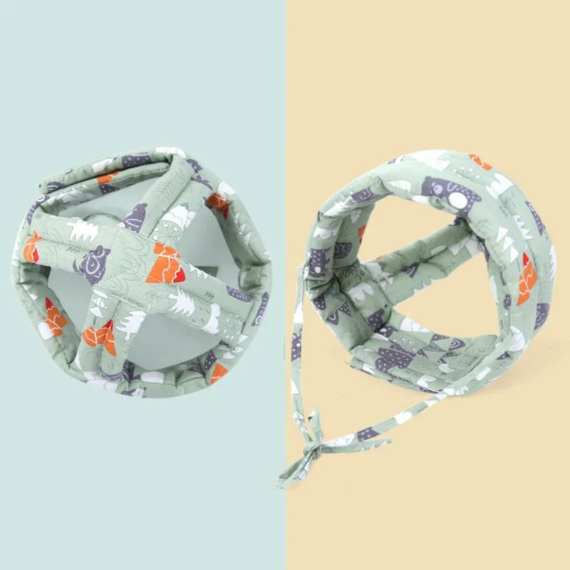 Adjustable green baby safety helmet with forest animal print, breathable cotton and sponge padding.