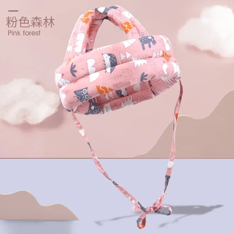 Pink forest-themed adjustable baby safety helmet with breathable, shock-absorbing cotton padding.