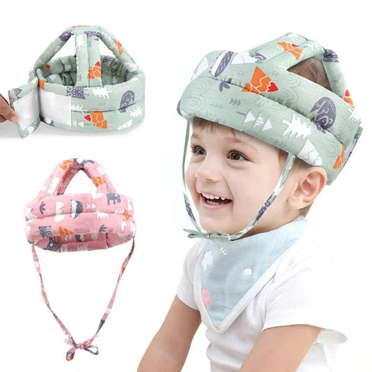 Adjustable green forest-print baby safety helmet on a child, with pink and green versions shown.