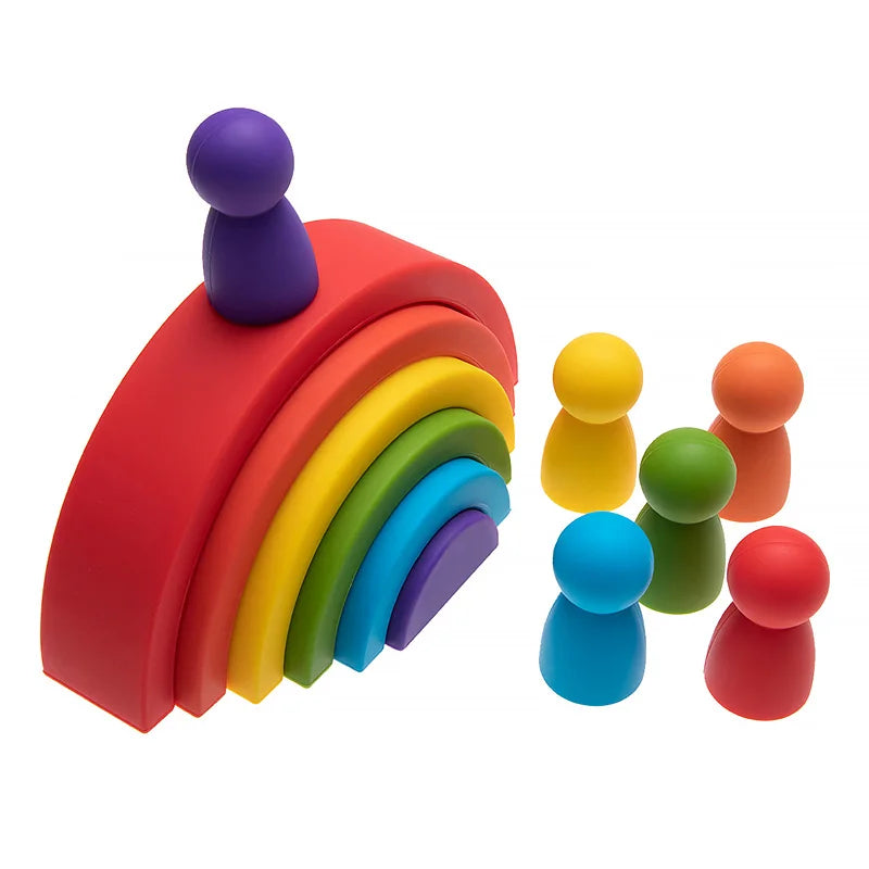 Colorful soft silicone rainbow stacker with six peg dolls for baby Montessori play.