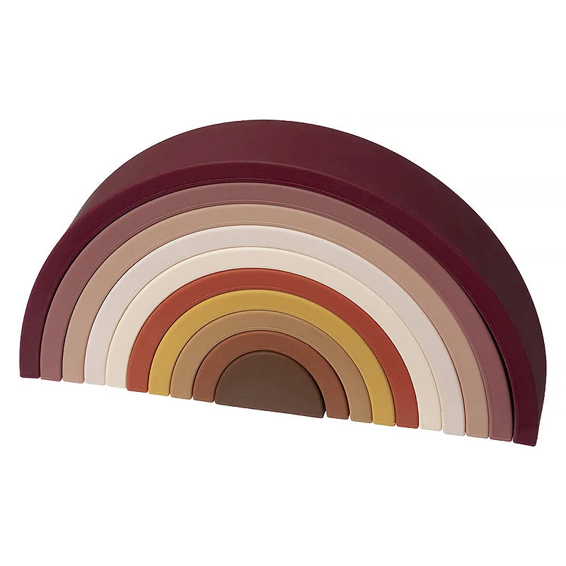Soft silicone rainbow stacker toy in earthy and neutral tones for Montessori play.
