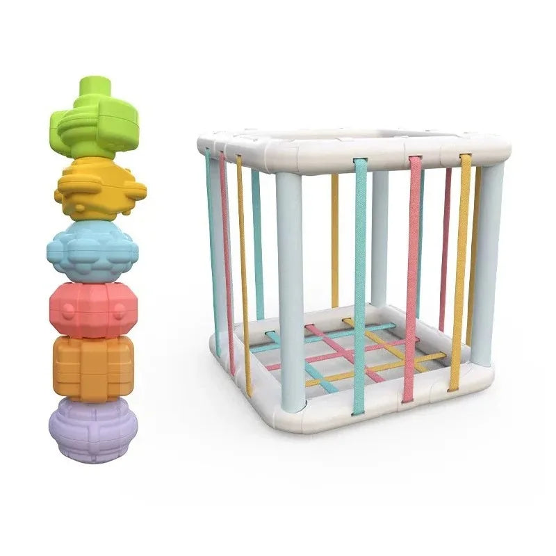 Montessori sorting cube with colorful elastic bands and five textured shape blocks.