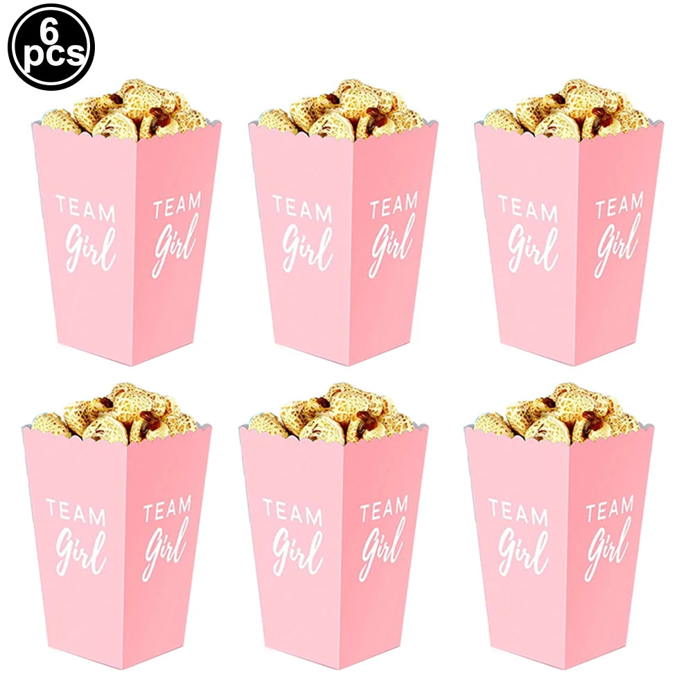 Six pink "Team Girl" popcorn boxes filled with snacks for baby showers or parties.