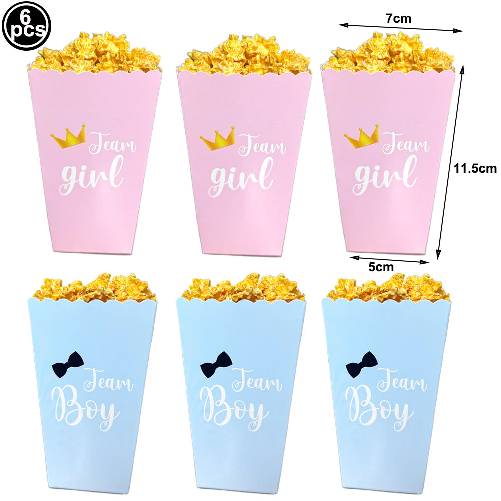 Pink "Team Girl" and blue "Team Boy" paper popcorn boxes with golden popcorn, showing dimensions.