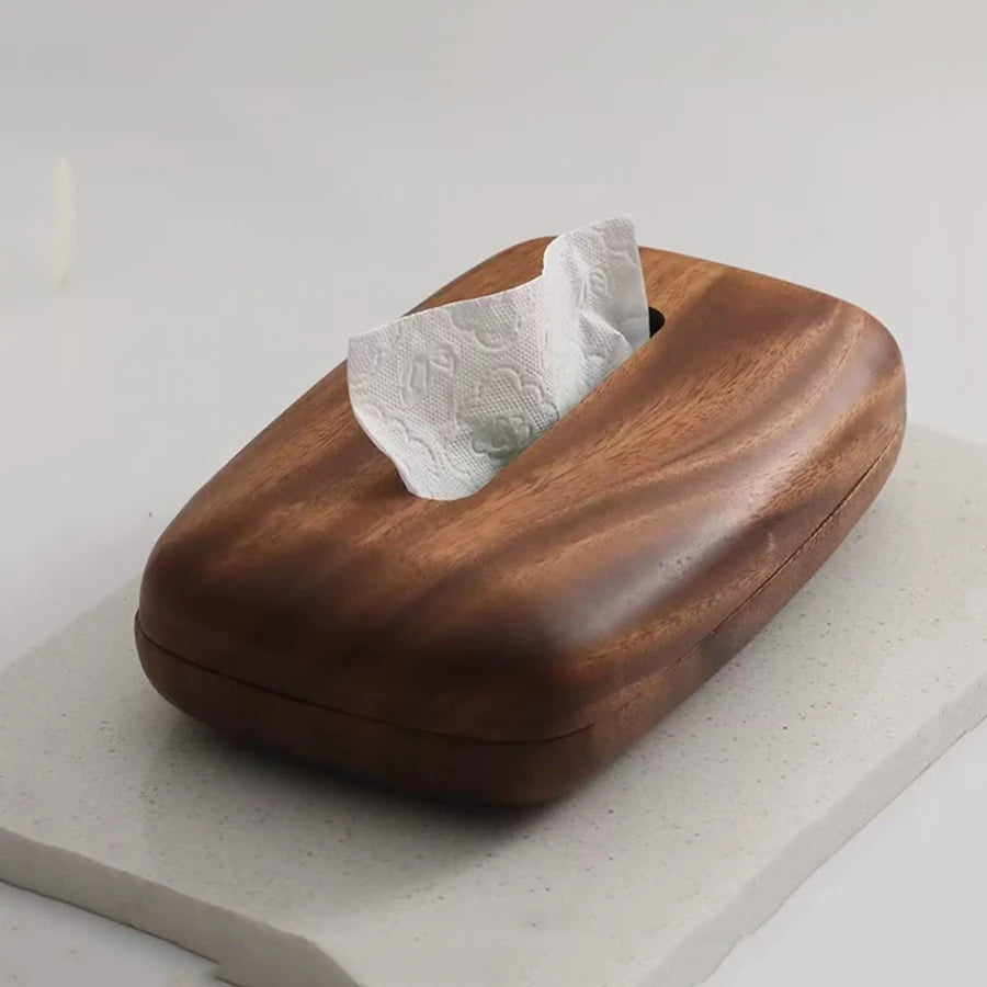 Vintage dark wood tissue box with a curved top and a white tissue peeking out.