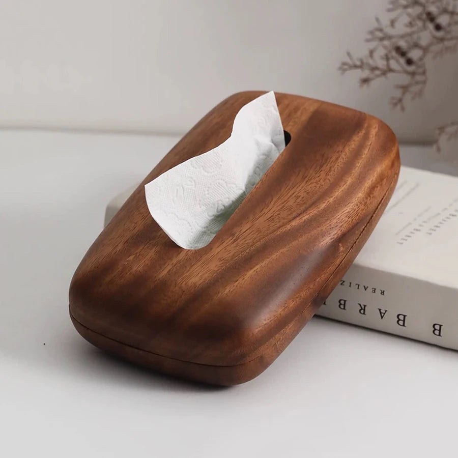 Vintage dark wood tissue box with a smooth, curved design and a white tissue emerging.