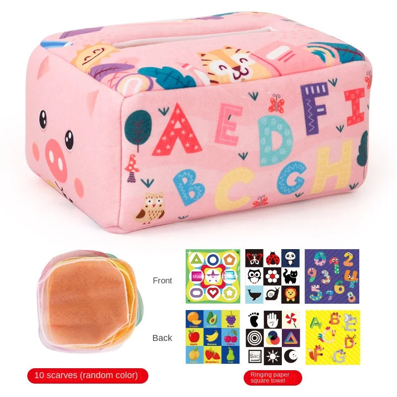 Pink plush Montessori tissue box toy with colorful letters, animals, and 10 random scarves.